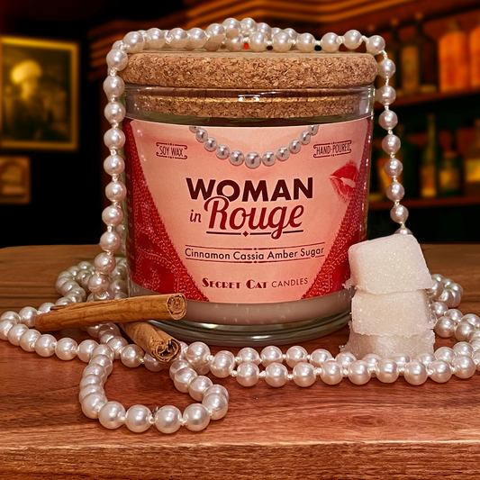 Candle called Woman in Rouge with pearls, cinnamon sticks, and sugar cubes with a speakeasy bar in the background.